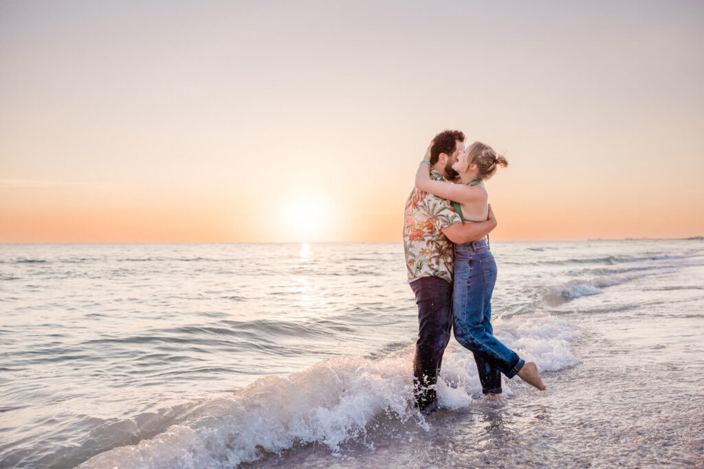 couple gets photos taken in the water on Treasure Island in St. Pete, FL