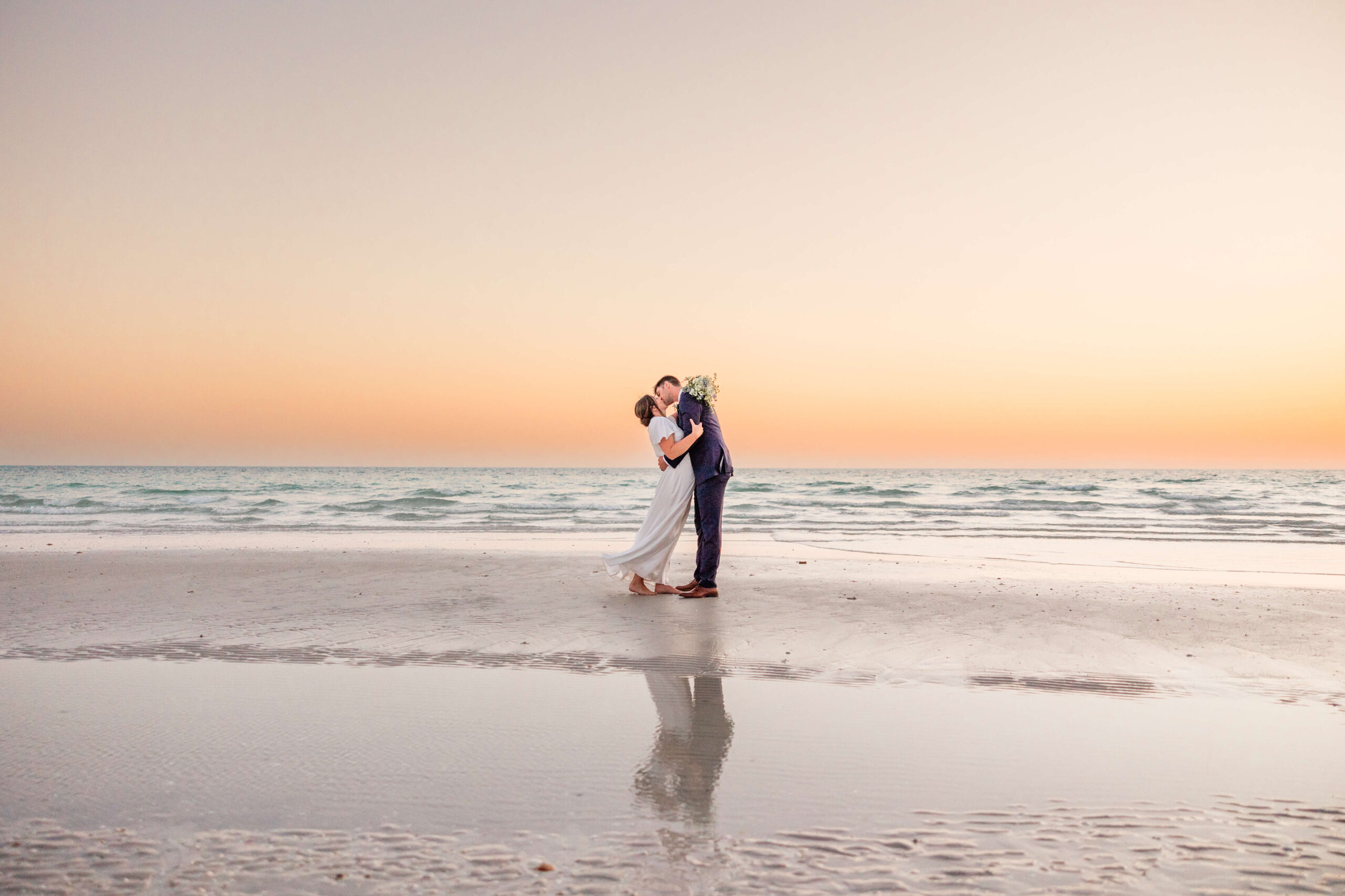 Couple in elopement photograph on Sunset Beach in Treasure Island near St. Pete, FL